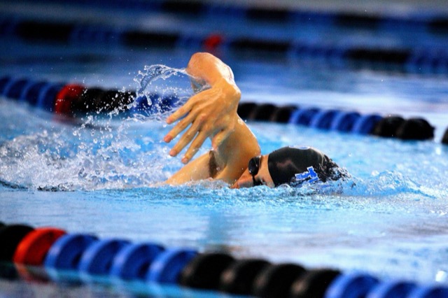 Close-up of a swimmer doing freestyle with a sports watch on their wrist